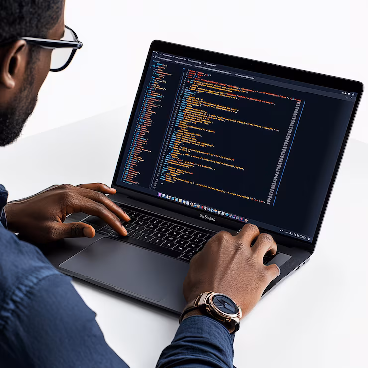 Engineer writing code on a laptop